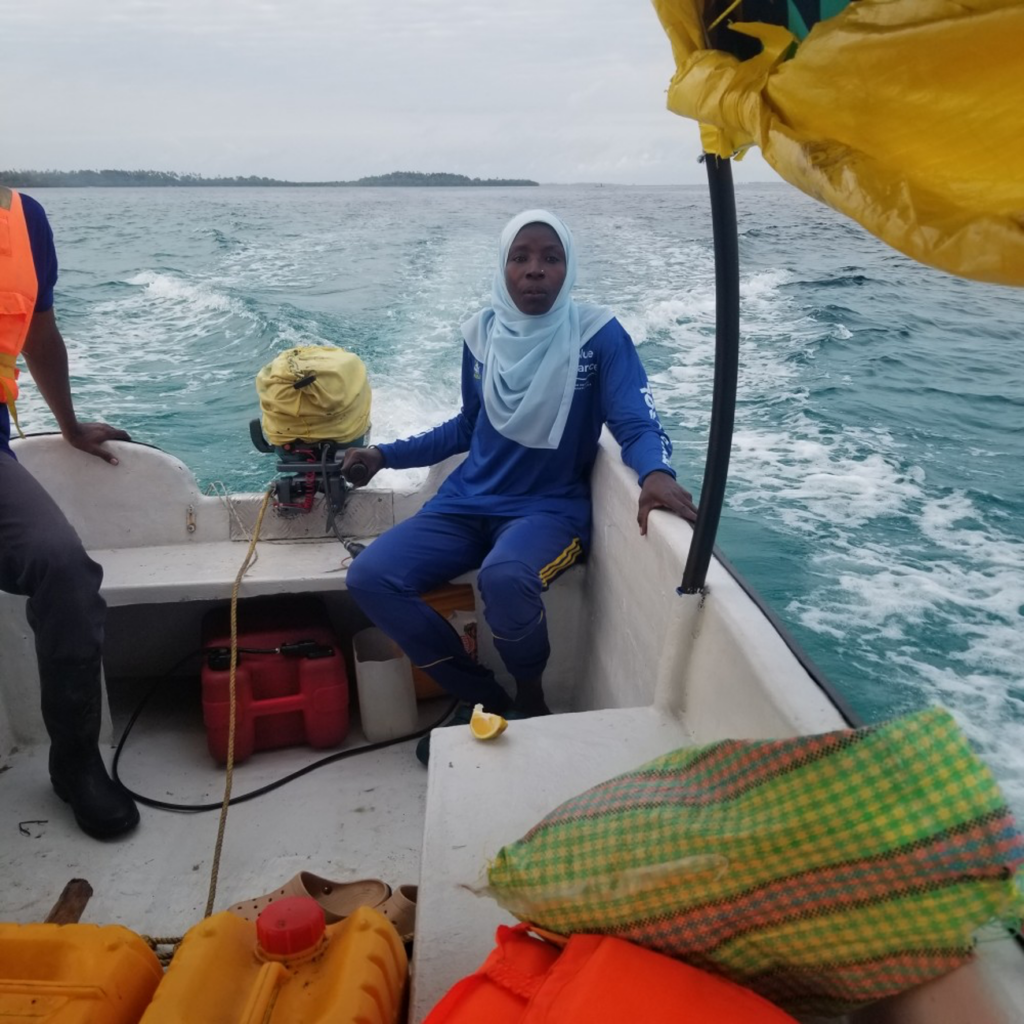 Ranger Asha Juma steering a boat during one of the regular sea patrols of Blue Alliance PECCA.